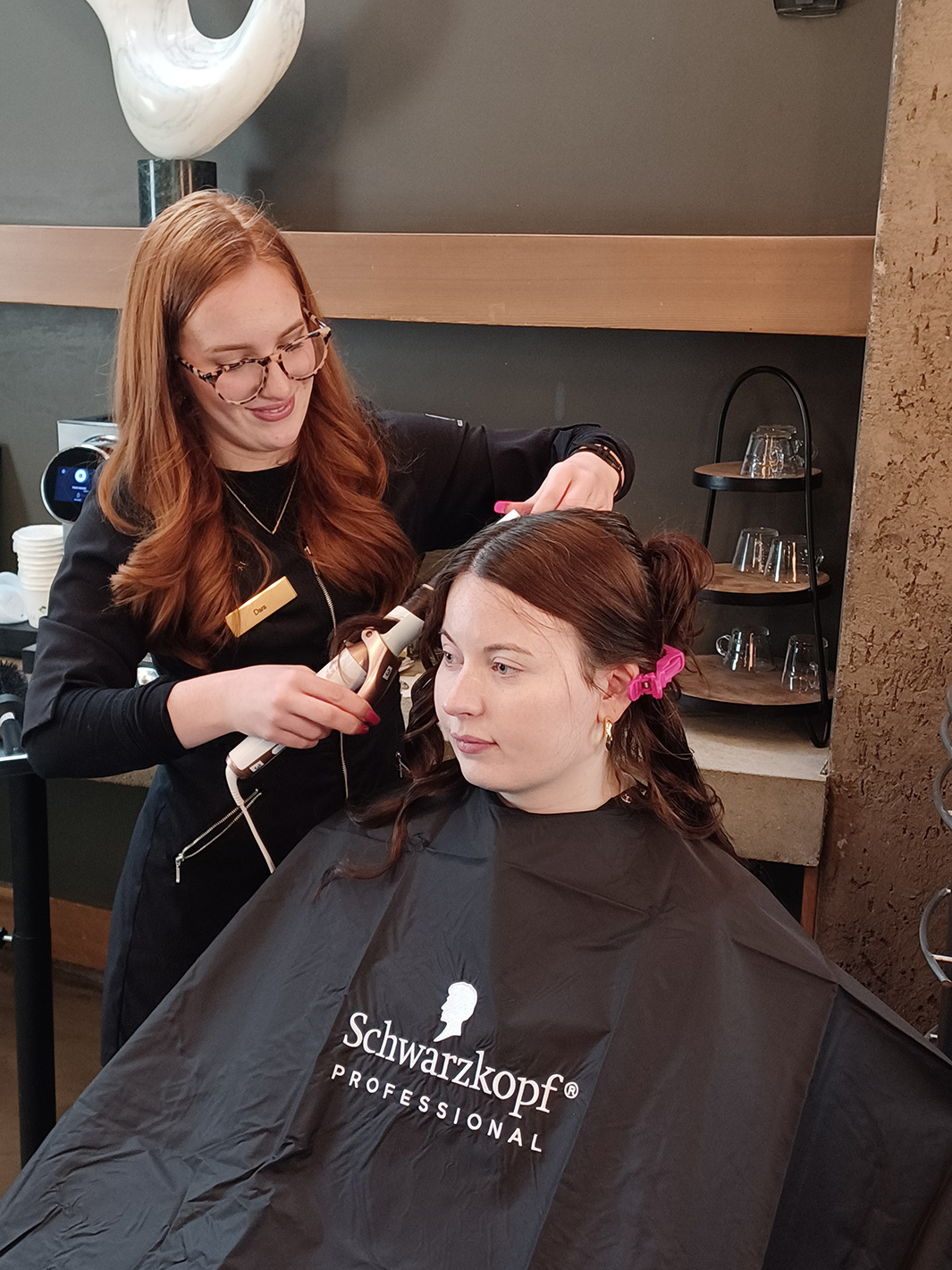 Salon staff doing a woman's hair
